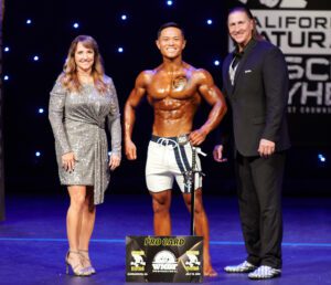 2023 INBF Natural Muscle Mayhem Open Physique Overall Winner WNBF Pro Kyle Okura Awarded by Bob Bell Tina Smith 2023 INBF Natural Muscle Mayhem Open Physique Overall Winner WNBF Pro Kyle Okura Awarded by Bob Bell Tina Smith
